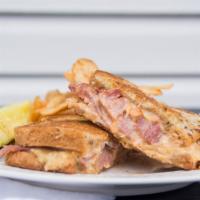 Reuben · Your choice of corned beef or turkey on grilled rye bread. Served with melted Swiss cheese, ...