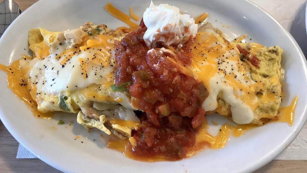 Chicken Fajita Omelette · Seasoned chicken, onions, peppers, Chile salsa and a blend of cheeses, topped with sour cream.