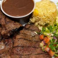 Carne Asada / Grilled Steak · Servida con frijol, arroz, ensalada de la casa, pico de gallo y dos tortillas. / With beans,...