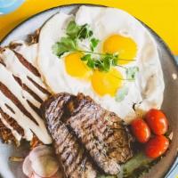 Ranchero Steak & Eggs · Three eggs any style, carne asada, fiesta hash browns on a bed of chimichurri sauce, topped ...
