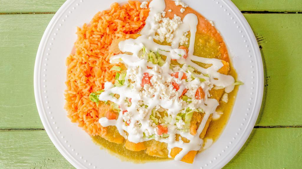 Enchiladas · 4 Corn tortillas rolled on your choice of either red or green sauce filled with pulled chicken and topped with either the green or red sauce you choose, lettuce, tomatoes , sour cream & queso fresco. Also comes with rice & beans on the side.