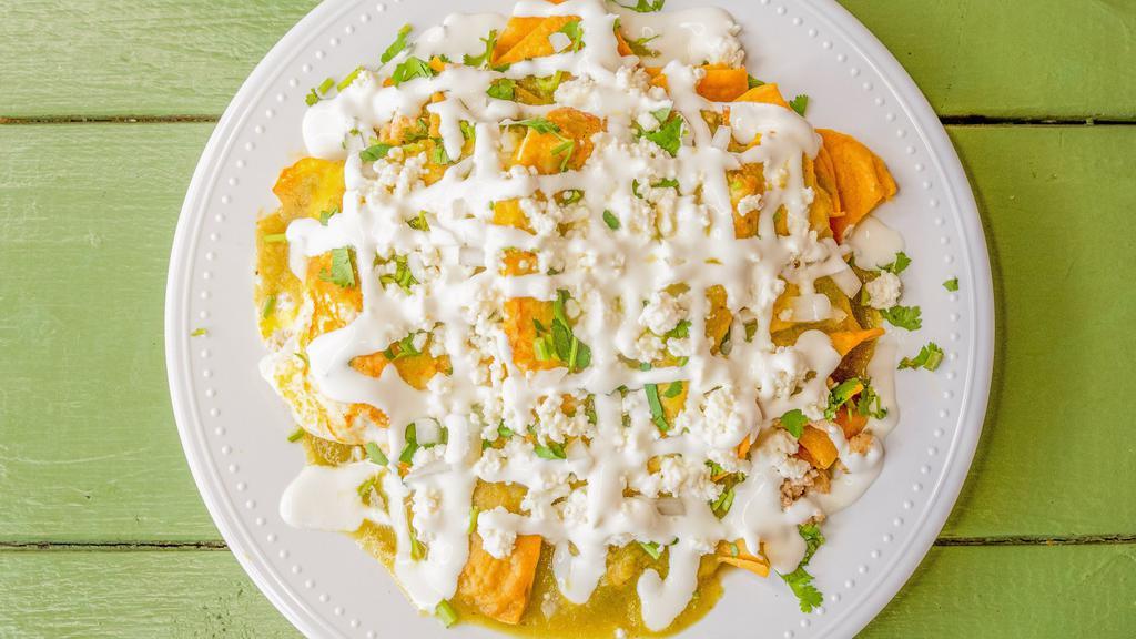 Chilaquiles · The chilaquiles come with refried pinto beans on the bottom, chips, eggs, onions, cilantro, sour cream & our queso fresco. Your choice of meat. Your choice of red or green sauce. Tripa, barbacoa, chorizo, shrimp & lengua for an extra cost.