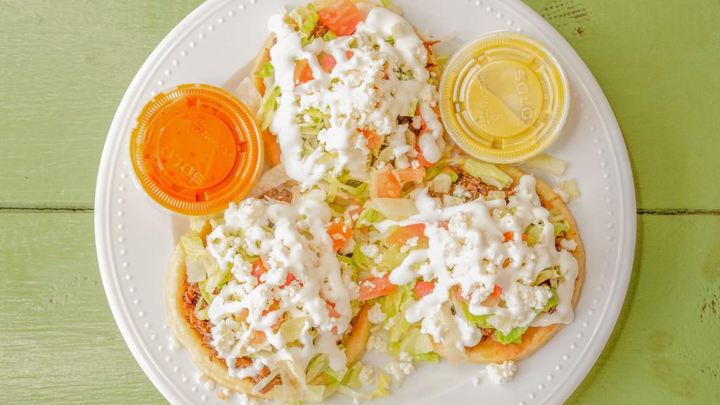 Sopes · Sopes are similar to the Gorditas but they are not cut through the middle . The sopes come with refried pinto beans at the bottom with your choice of meat, lettuce, tomatoes, sour cream & queso fresco . Also your choice of either mild or hot sauce .
