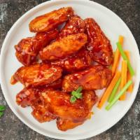 Buffalo Basher Wings · Fresh chicken wings breaded, fried until golden brown, and tossed in buffalo sauce. Served c...