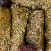 Dolmas V Vg Soy · Vegetarian-friendly stuffed grape leaves drizzled with lemon sauce, served with pita bread.