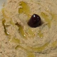 Hummus V Vg · A smooth blend of chickpeas, fresh garlic, tahini, lemon juice and olive oil and herbs, serv...