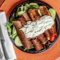 Gyro Salad · Garden salad topped with gyro meat and tzatziki.