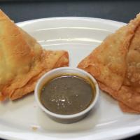 Vegetable Samosas (V) (2Pc) · Golden fried, filled with potatoes, and green peas, flaky pastry served with our cilantro an...