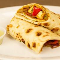 Kathi Roll Paneer · Skewer-roasted paneer wrapped in house sauce with  paratha bread.