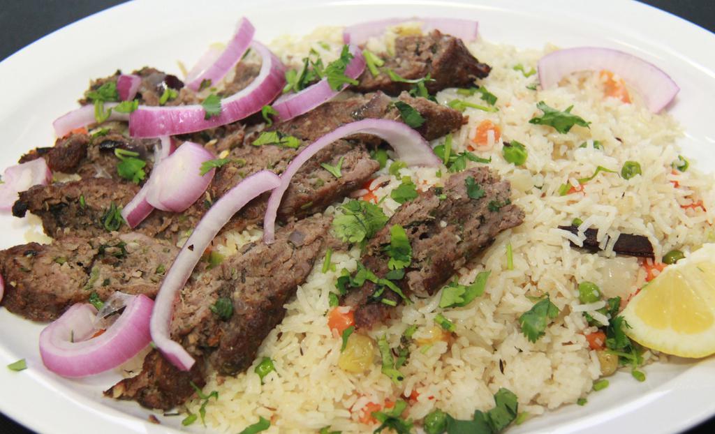 Lamb Seekh Kabab · Finely minced lamb marinated with fresh ground herbs and spices, cooked in traditional clay.