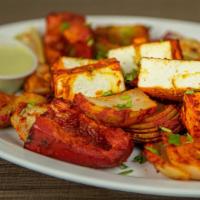 Tandoori Paneer · Cubes of paneer with variety of bell peppers and onion marinated in yogurt and Indian spices...