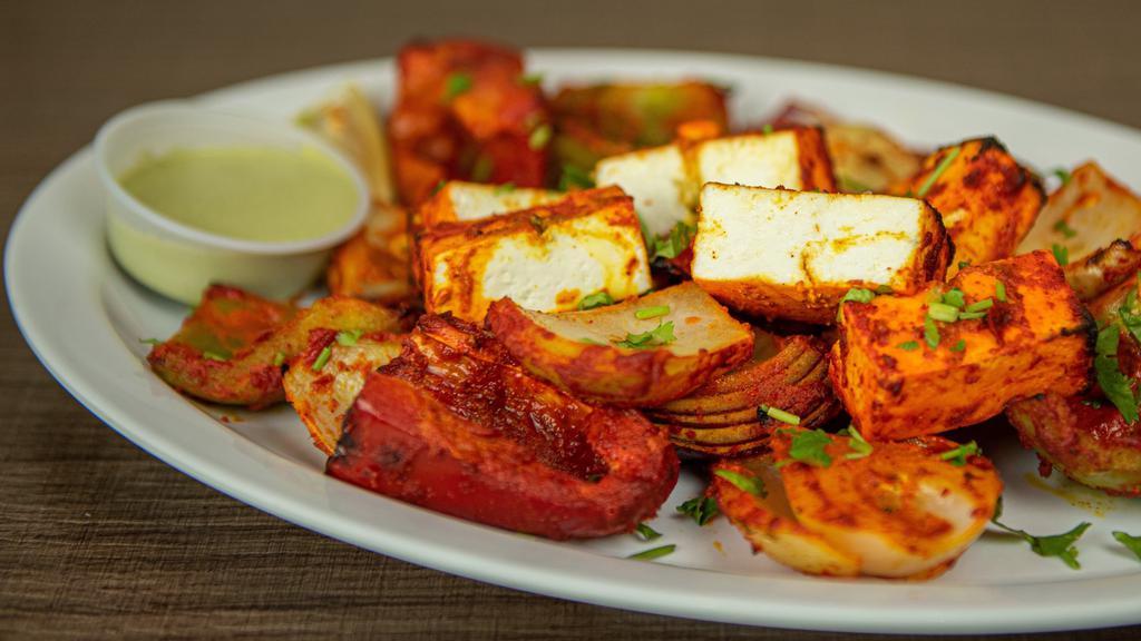 Tandoori Paneer · Cubes of paneer with variety of bell peppers and onion marinated in yogurt and Indian spices cooked in traditional clay oven.   Served with house made mint chutney.