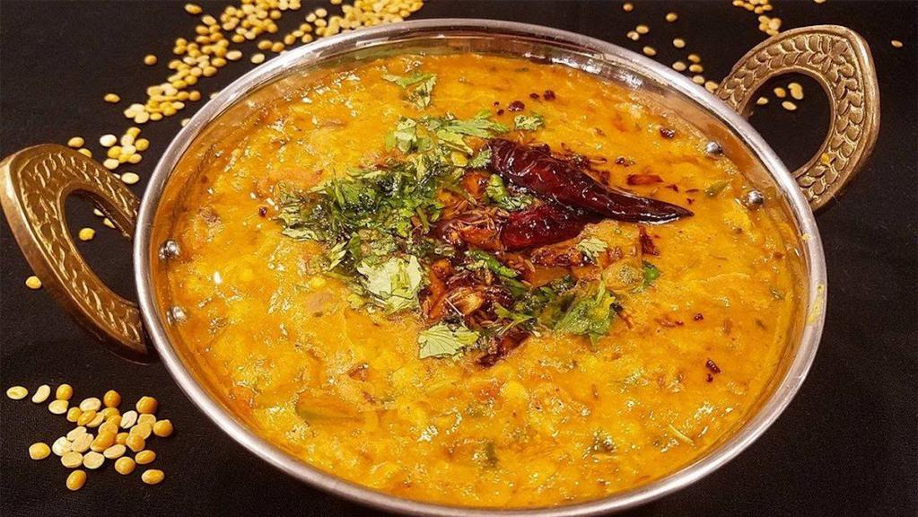 Dal Tadka (G) · Simmered yellow lentil in lightly spiced butter, cooked with ginger, garlic, tomatoes, onions and cumin tarka.