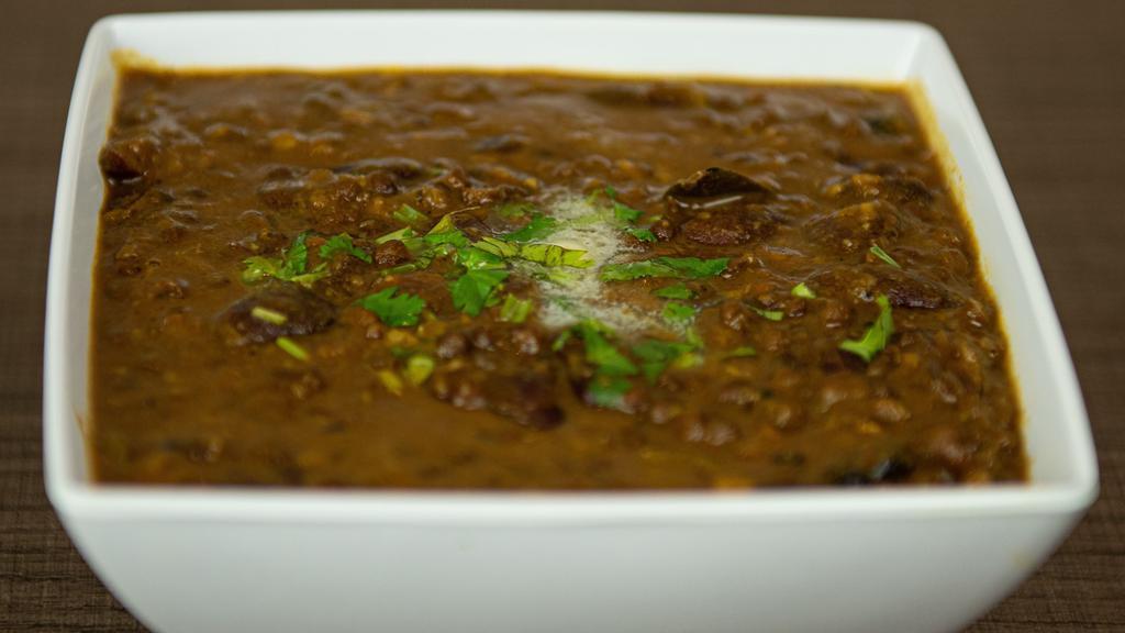 Dal Makhani (V) (G) · Traditional North Indian dish, simmered black lentils, cooked with ginger, garlic, tomatoes, onion, and touch of cream.
