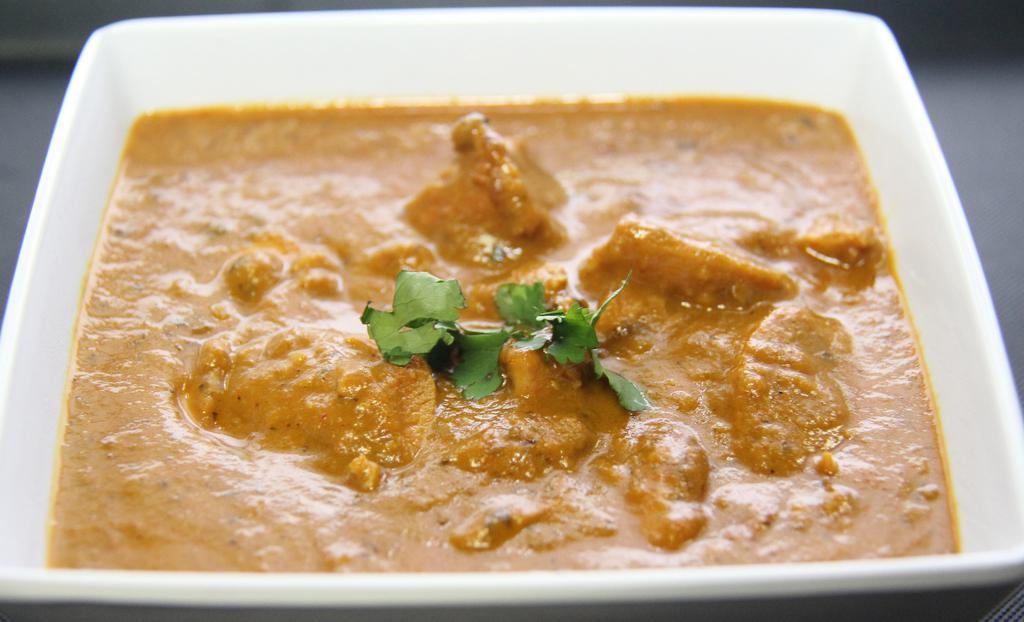 Butter Chicken (G) · Boneless  halal chicken  thigh cubes cooked in clay oven, cooked in special curry base of vine ripened tomatoes, special spices, touch of butter and fenugreek herbs.