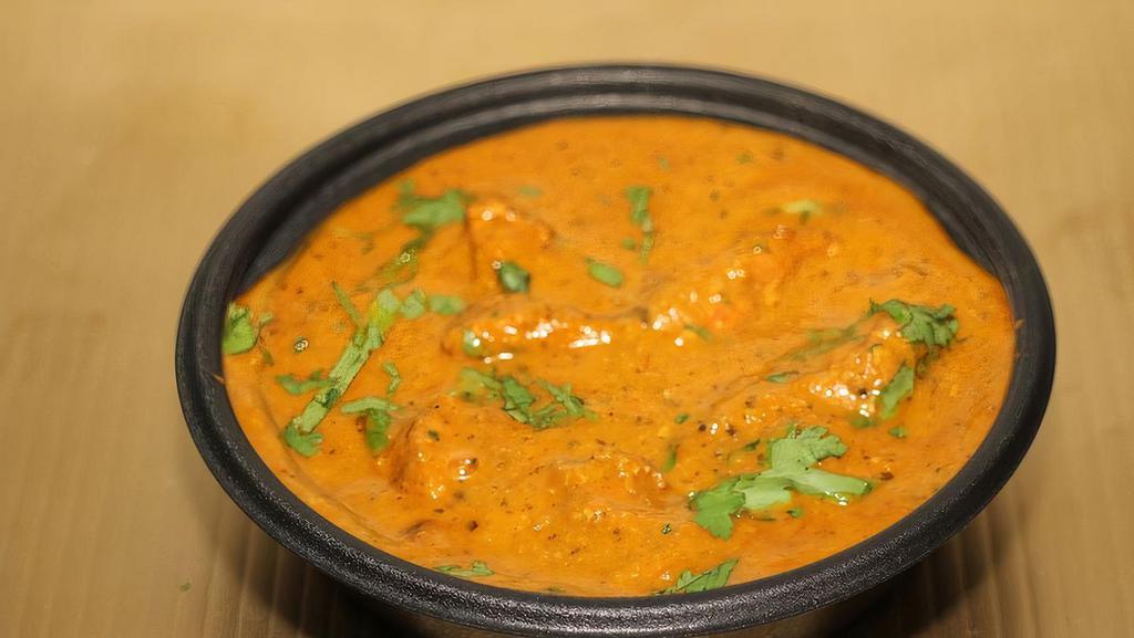 Chicken Korma (G) · Boneless Halal chicken thigh cooked in mild yogurt base curry sauce with a touch of cream and cashews.