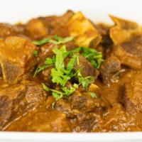 Goat Curry (G) · Halal Goat meat with bones in, cooked with ginger, garlic, onions, and fine blend of dry spi...