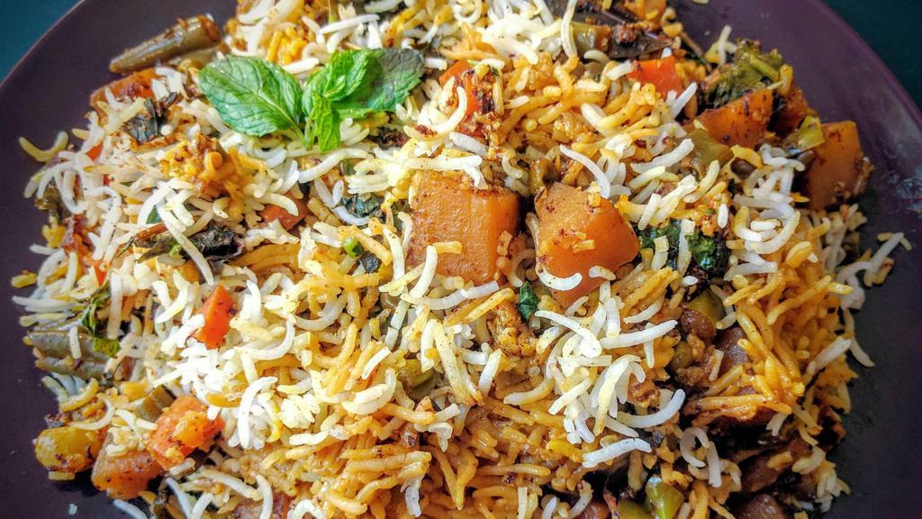 Vegetarian Biryani · Vegetable biryani is an aromatic rice dish made by cooking basmati rice with mix veggies, herbs & biryani spices.
