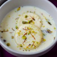 Ras Malai · Creamed cheese patties prepared in sweetened milk, flavored with cardamom and pistachio