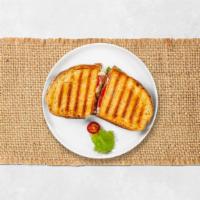 Cheesy Turkey Panini · Oven gold turkey, salsalito turkey, melted Vermont cheese, beef bacon, grilled onions, peppe...