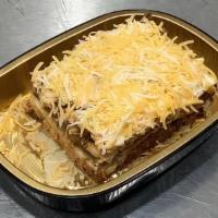 Beef Stacked Enchiladas · Hearty shredded beef stacked beef enchiladas topped with cheddar cheese