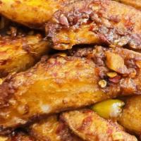 Chili Potato Dry · Crispy potato wedges stir-fried with fresh green chilies, onions and bell peppers.
