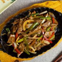 Peppered Steak · Pan-fried beef cooked in black pepper sauce.