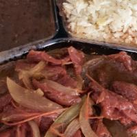 Bistec Salvadoreño · Thinly cut steak simmered in sauce of tomatoes, onions and bell peppers.
with rice, beans an...