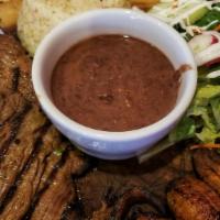 Carne Asada · Grilled flank steak.
with rice, beans and salad