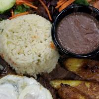 Desayuno Hondureño · Grilled steak (carne asada) 2 eggs over easy, fried plantains, rice beans, plantains, beans,...