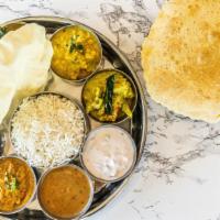 Veg Thali · An assorted platter thali of poriyal, avial, sambar, rasam, kottu, vegetable of the day, dal...