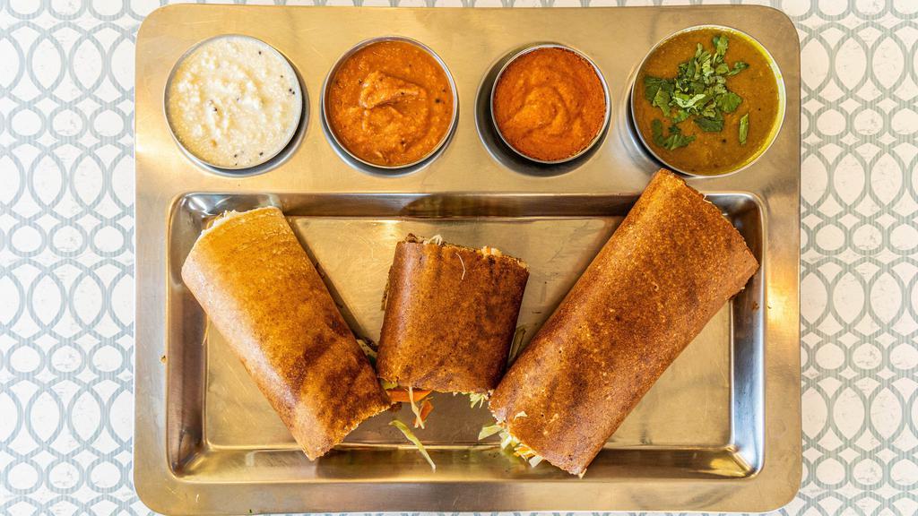 Madras Spring Dosa · Rice crepe spread with a spicy Mysore chutney, stuffed with potato masala and mixed crunchy vegetables.