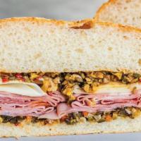 Muffuletta · Our Take on the Classic ‘Central Grocery’ Version with Ham, Mortadella, Salami, Provolone, a...