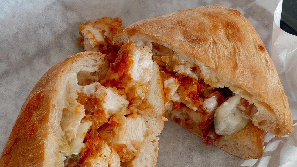 Hot Wang · Crispy Chicken Tender with Buffalo Sauce, Crispy Bacon, Pickled Celery, Blue Cheese Ranch Dressing, on Ciabatta