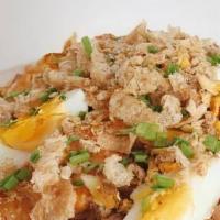 Palabok · noodle dish topped with shrimp gravy, shrimp, smoked fish flakes, pork cracklings, and eggs....