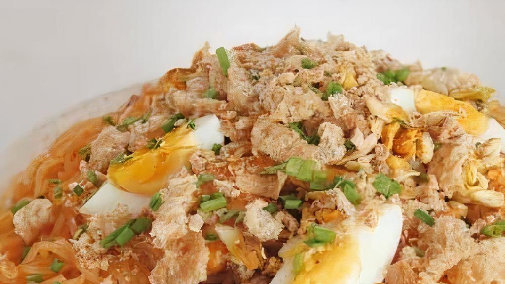 Palabok · noodle dish topped with shrimp gravy, shrimp, smoked fish flakes, pork cracklings, and eggs. Hearty and savory,