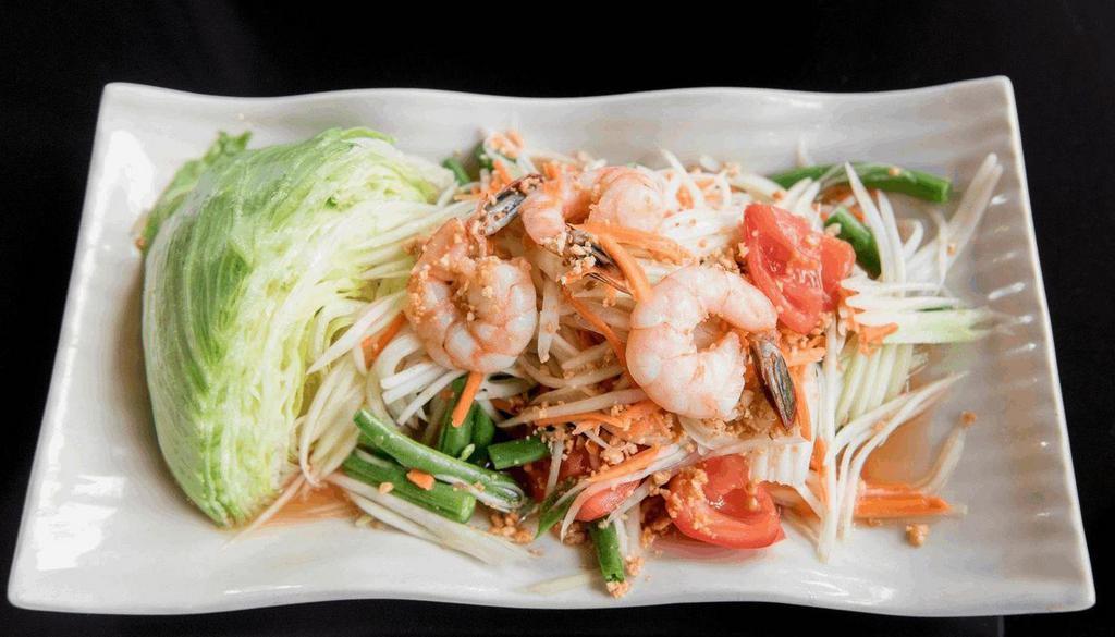 Papaya Salad (Som Tum)  · Shredded green papaya and carrot mixed with. tomato, green bean and shrimps. Tossed in lime. and fish sauce dressing and topped with ground. peanut.