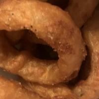 Beer-Battered Onion Rings · Thick-cut onion rings slathered with a generous coating of beer batter and fried to golden p...
