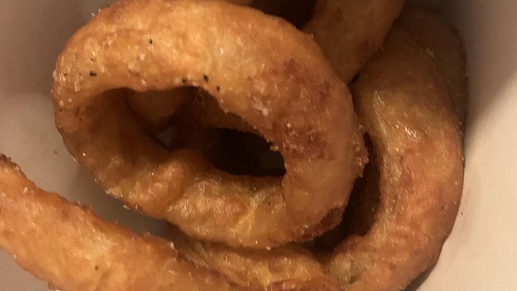 Beer-Battered Onion Rings · Thick-cut onion rings slathered with a generous coating of beer batter and fried to golden perfection.