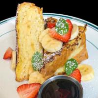 Banana Pudding Stuffed French Toast · Brioche bread, sliced banana, strawberries, maple syrup