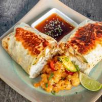 Sesame Chicken Burrito · Crispy Chicken with bell peppers and onions served in a tangy sesame sauce!