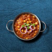 Savory Chickpeas Masala · Garbanzo beans cooked in juicy onions, tomatoes, and perfectly grounded spices. Served with ...
