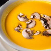 Pumpkin Bisque · Steamed Pumpkin Pureed & Simmered, Topped with Sliced Button Mushroom