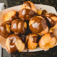 Chocolate Donut Holes (Dozen) · 1 dozen chocolate drizzled donut holes.