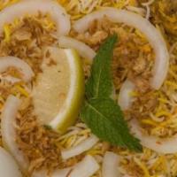 Chicken Biryani · Basmati rice cooked with chicken with bone, Indian herbs and garnished with cilantro and lim...