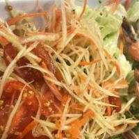 Papaya Salad With Grilled Shrimp · Shredded green papaya with green beans, cherry tomatoes, garlic, lime juice, peanuts and chi...