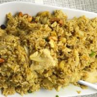 Pineapple Fried Rice · Stir-fried jasmine rice with eggs, madras curry powder, white onions, raisins, cashew nuts a...