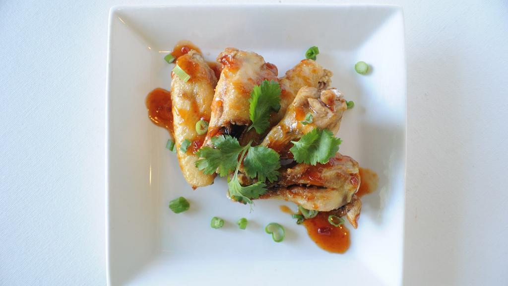 Chicken Wings · Six pcs crispy chicken wings tossed in our house special spicy-tamarind sauce.