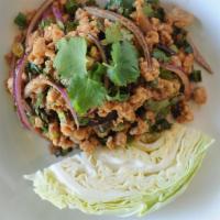 Larb · Minced meat salad flavored with fish sauce, lime juice, and roasted ground rice ad herbs. Se...