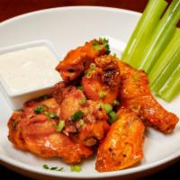 Buffalo Wings · One-pound of mouth-watering fried chicken wings tossed in buffalo, sweet chili,  BBQ sauce o...